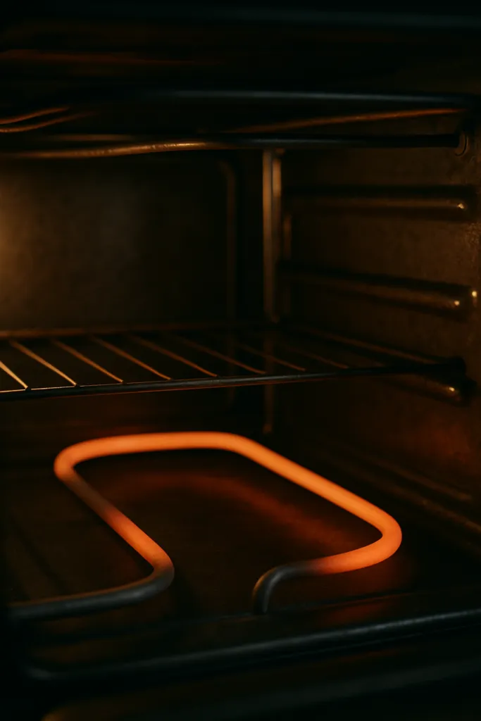Oven heating element inspected for a repair